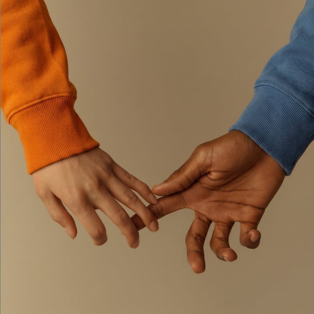 Two hands reaching for each other